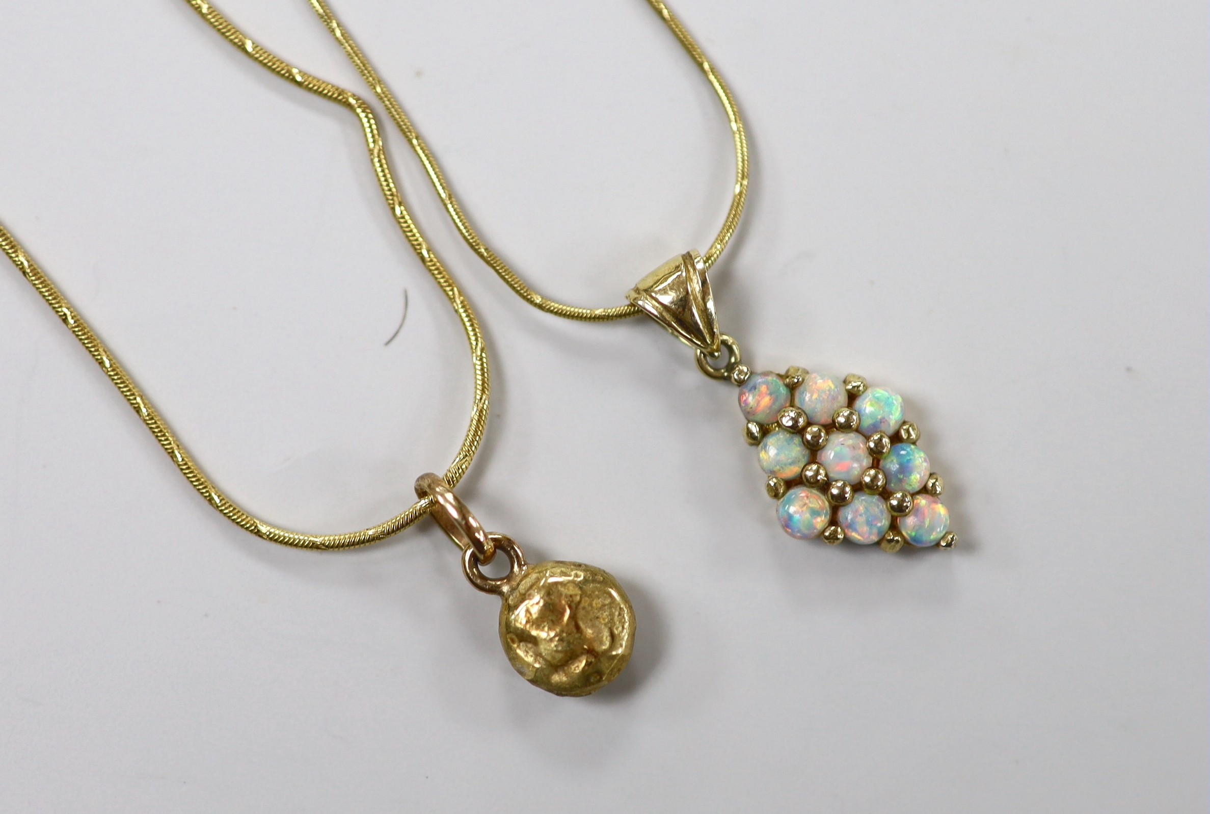 A modern 585 and white opal cluster set diamond shaped pendant, 17mm, on a 14k chain, 43cm and a yellow metal pendant on a 14kt chain, gross weight 11 grams.